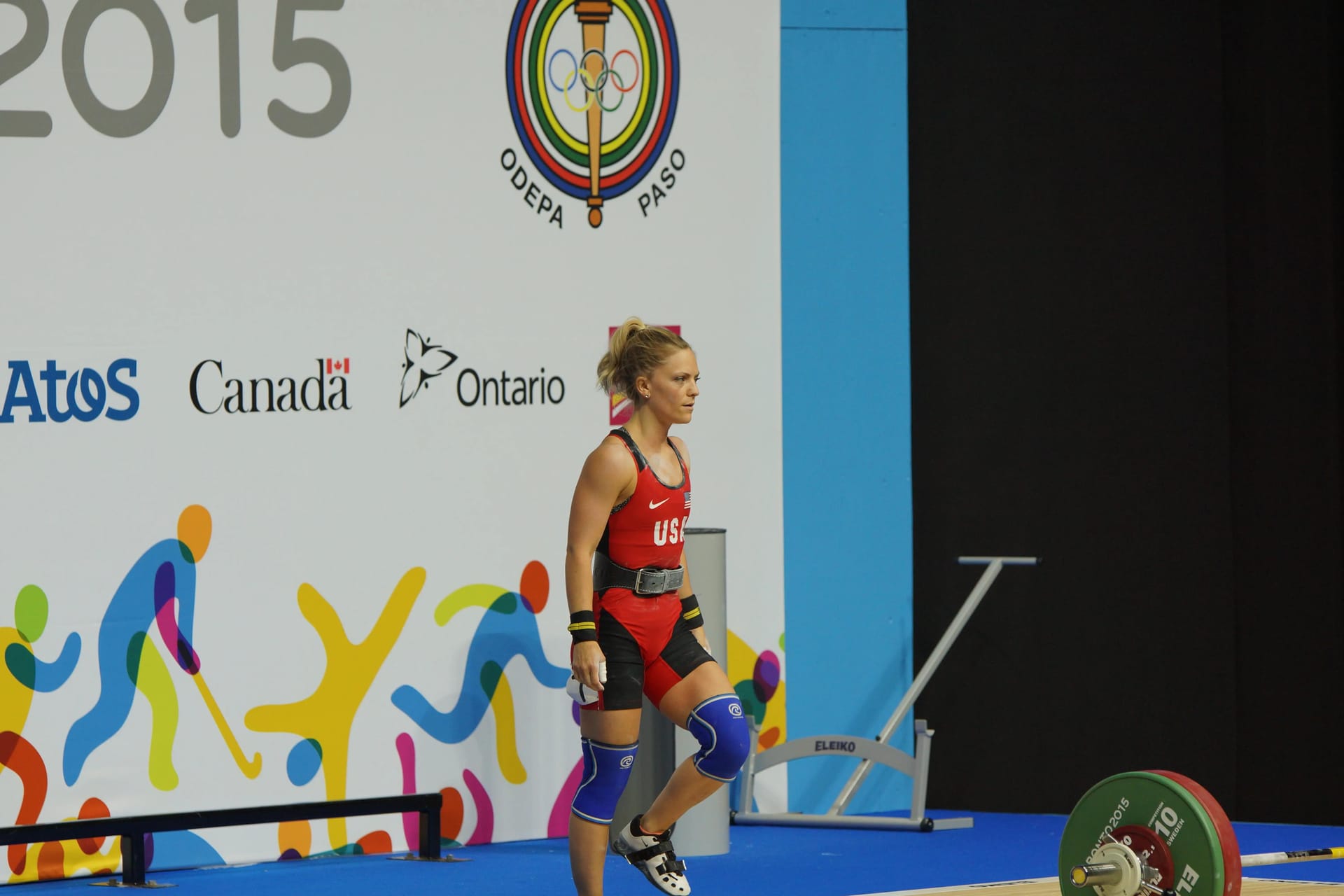 Morghan approaching weight bar on a competition stage