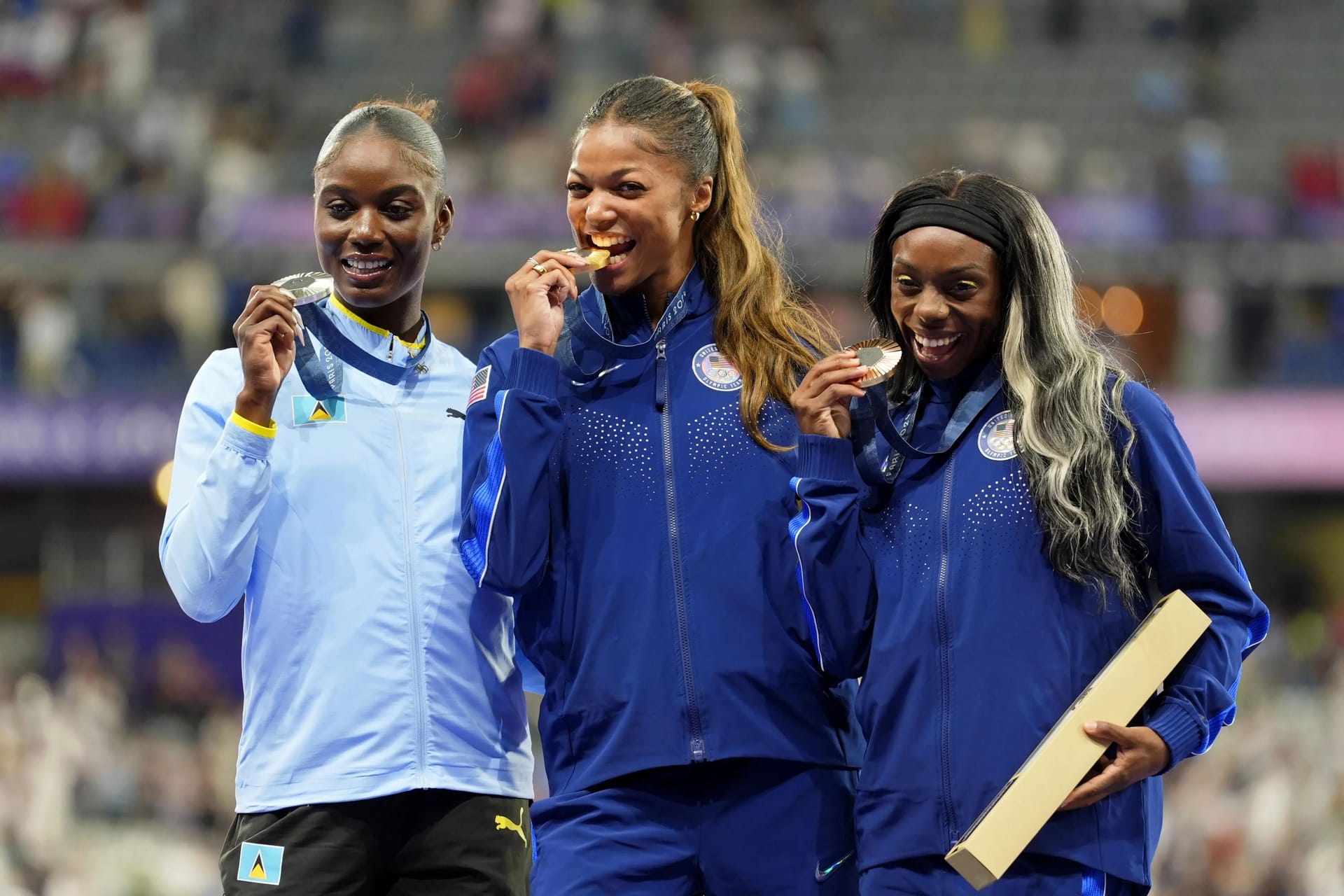 Gabrielle Thomas (USA), Julien Alfred (LCA), and Brittany Brown (USA) celebrate their medals at the Paris 2024 Olympics