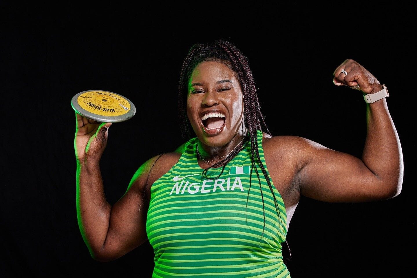 Chioma Onyekwere-Lyons smiling and posing with disc for Team Nigeria