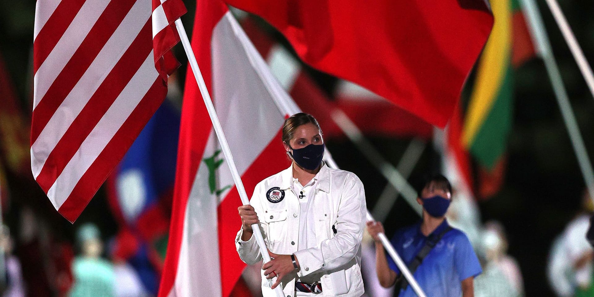 Kara Winger holding American flag at Olympic ceremony