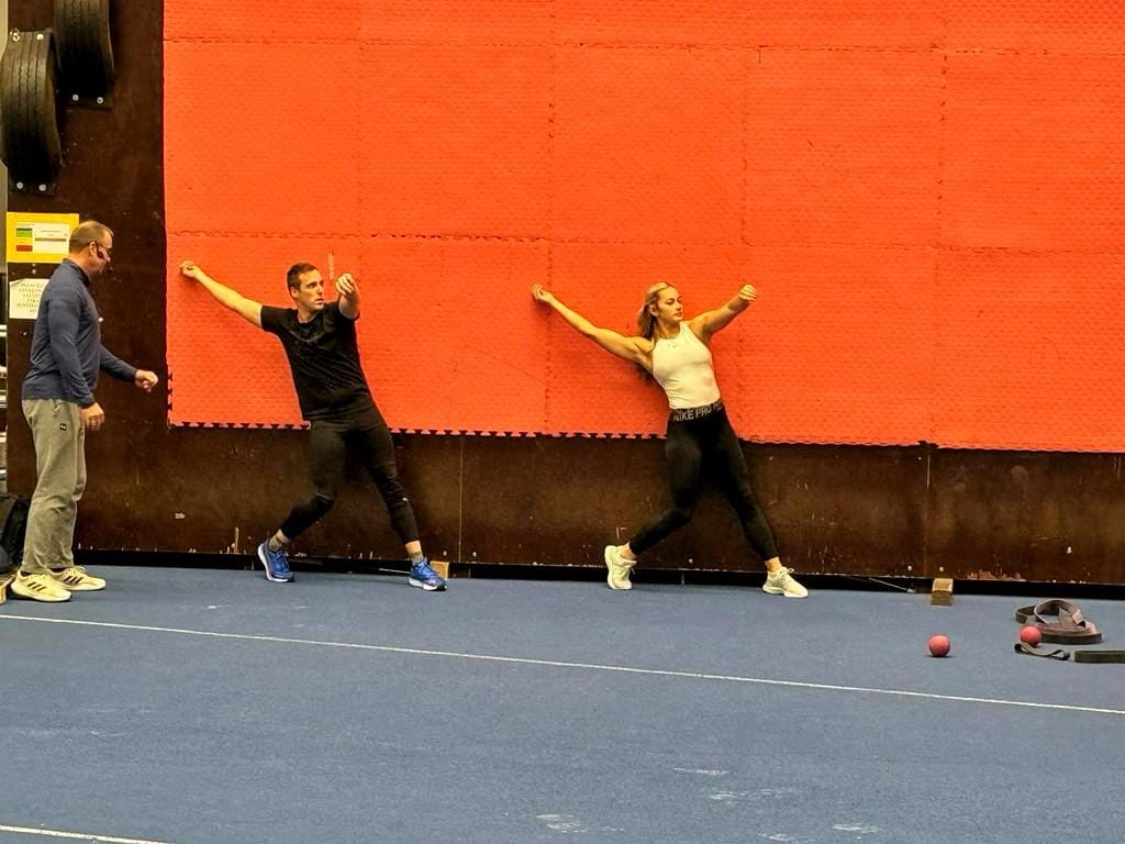 Marija practicing her form with coach and trainer