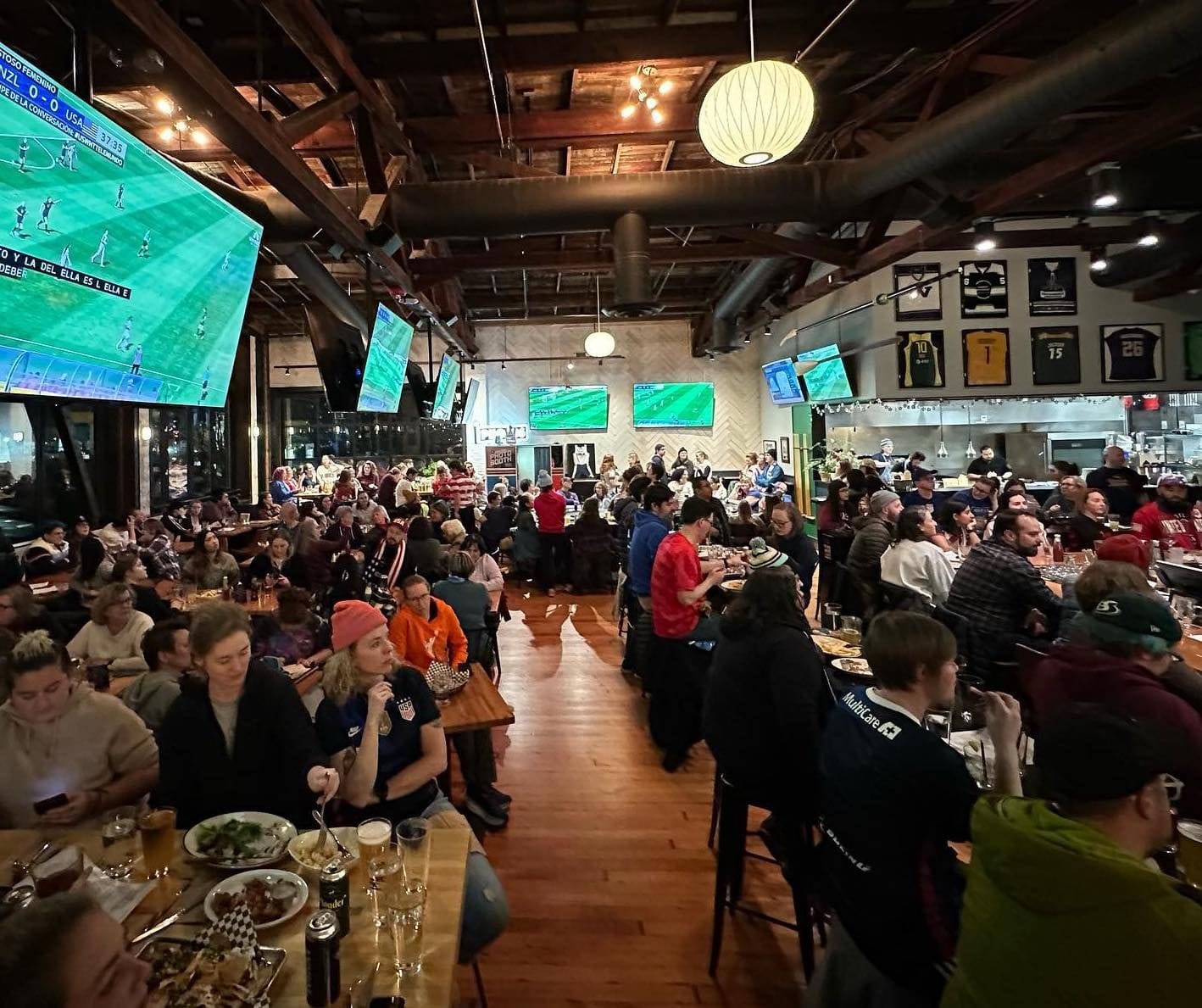 photo of a crowded sports bar during a soccer game