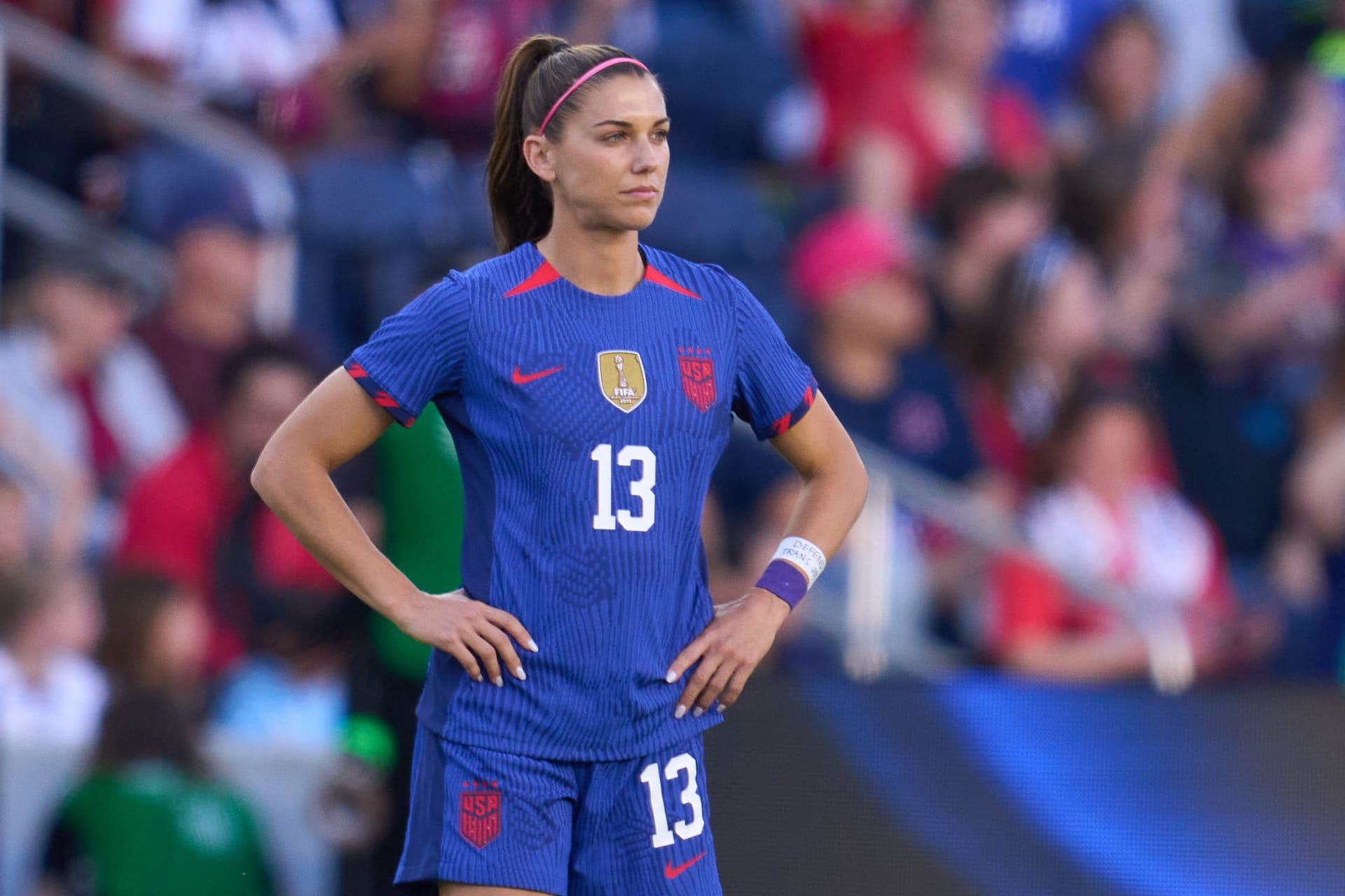 female Team USA soccer player standing on the field