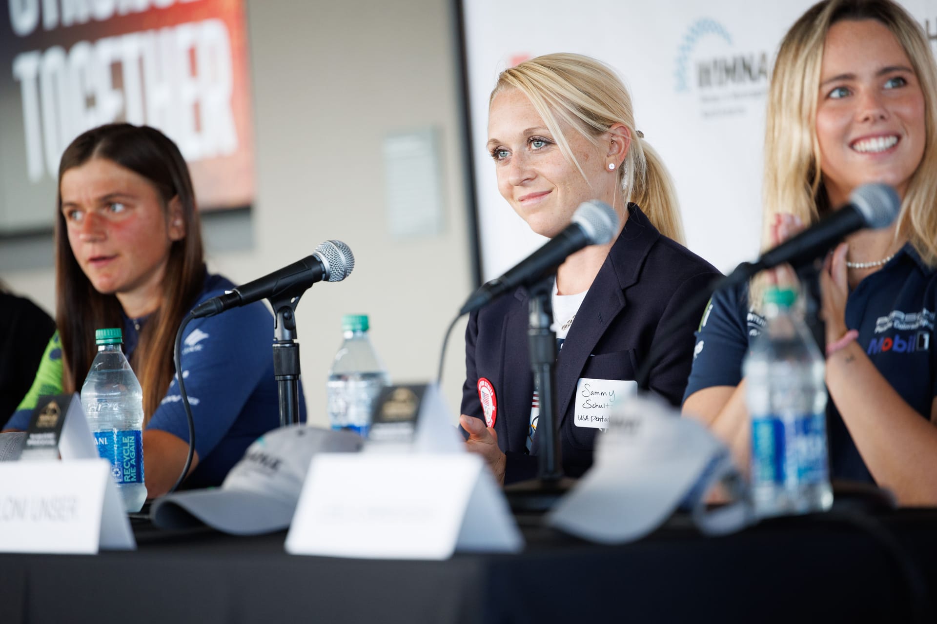 Sammy Schultz and other athletes smile on a speaking panel