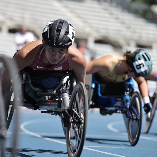 closeup action shot of Hannah wheelchair racing