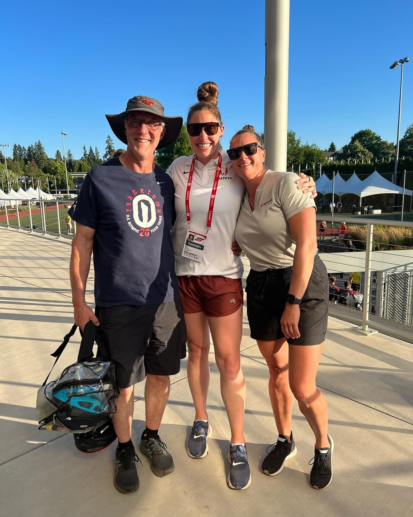 Kara and two friends posing together at a track event