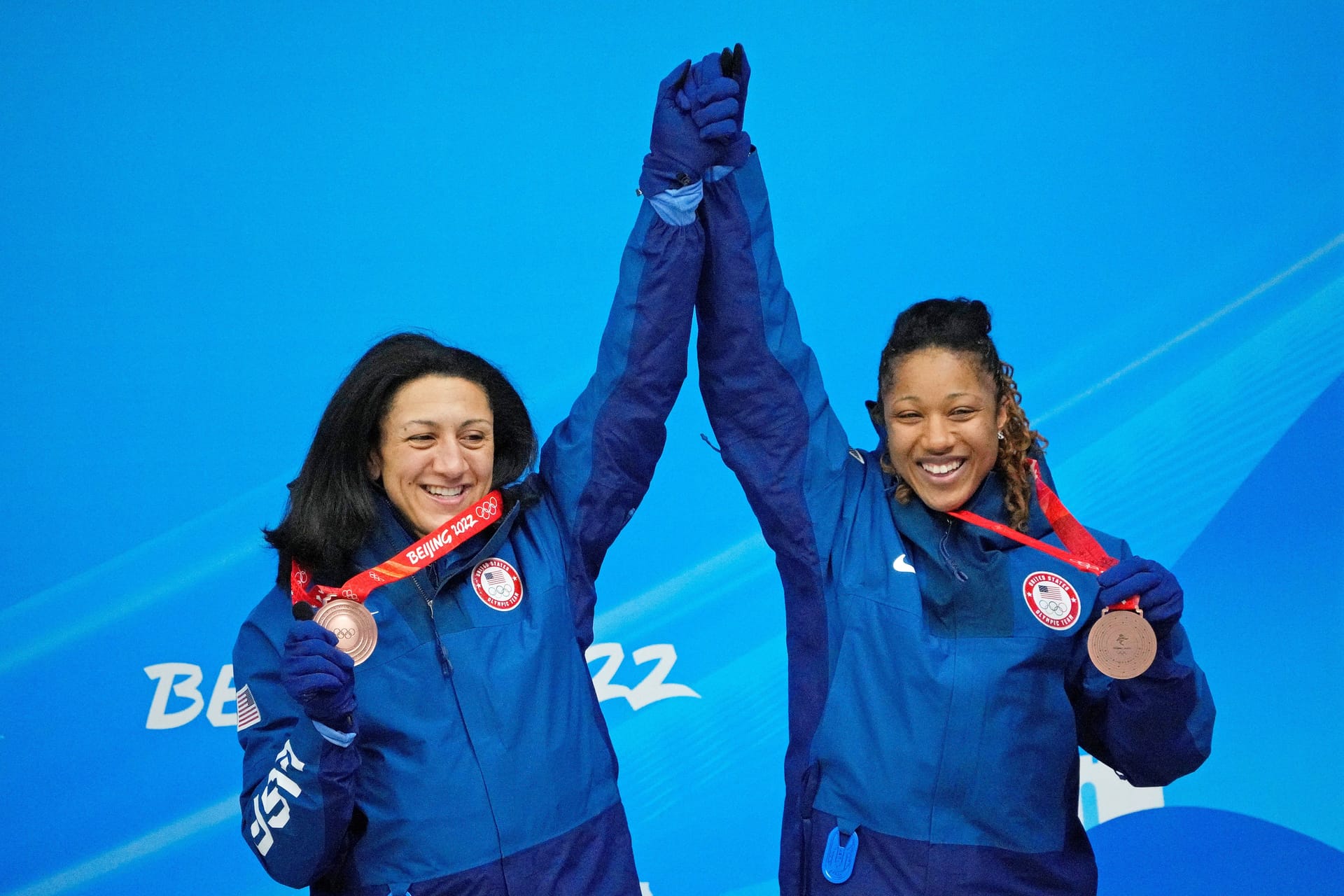 Feb 19, 2022; Yanqing, China; Elana Meyers Taylor and Sylvia Hoffman (USA) celebrate after winning the bronze medal in 2-woman bobsleigh during the Beijing 2022 Olympic Winter Games at Yanqing Sliding Centre. Credit: Andrew P. Scott-Imagn Images
