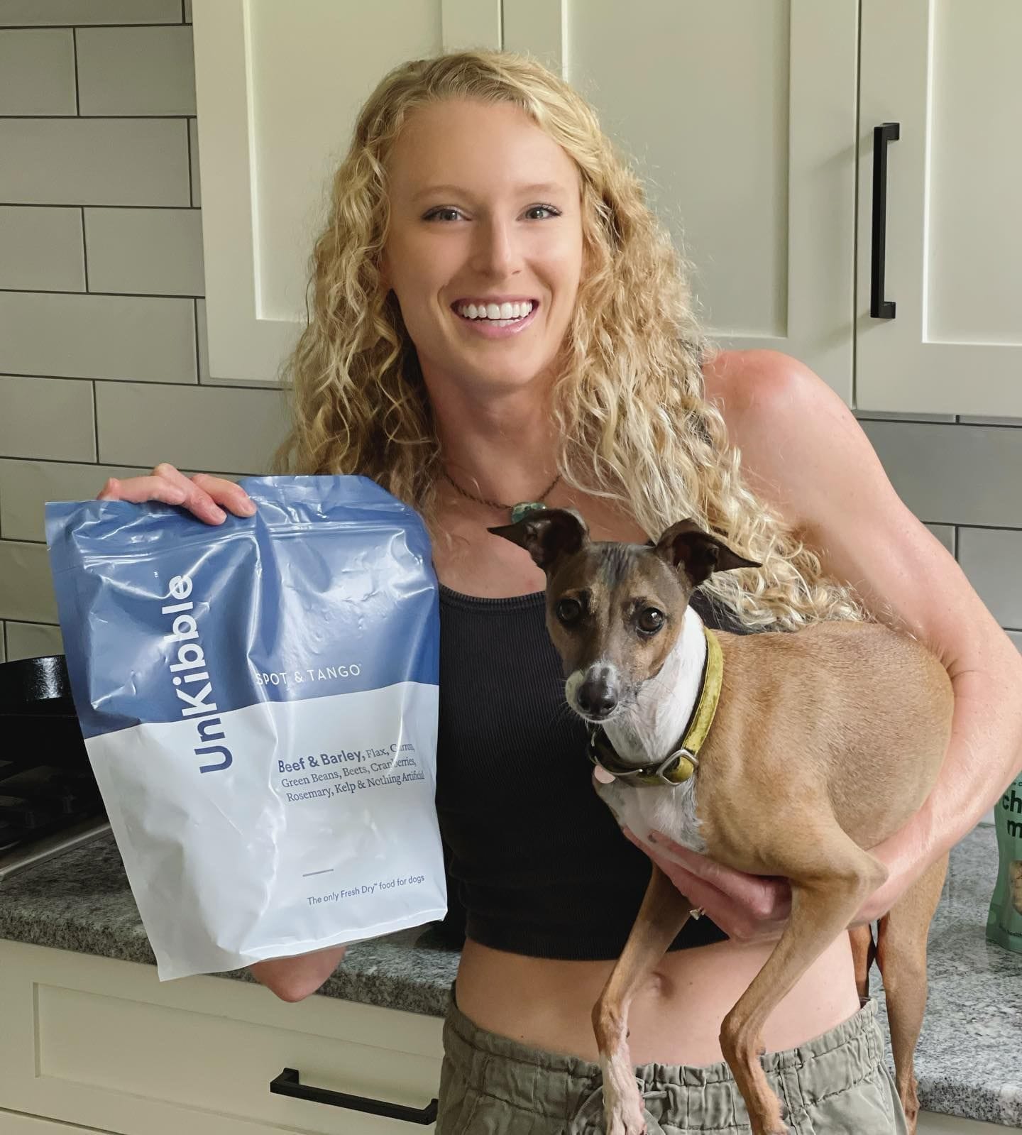 Sandi Morris poses with her dog and a bag of Spot & Tango kibble