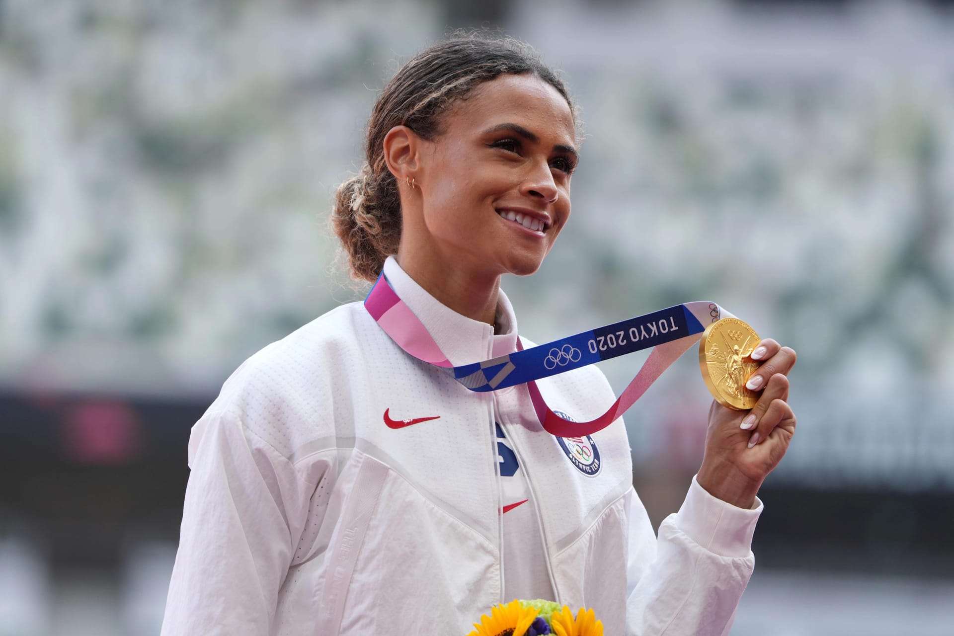 Sydney McLaughlin posing with Olympic gold medal
