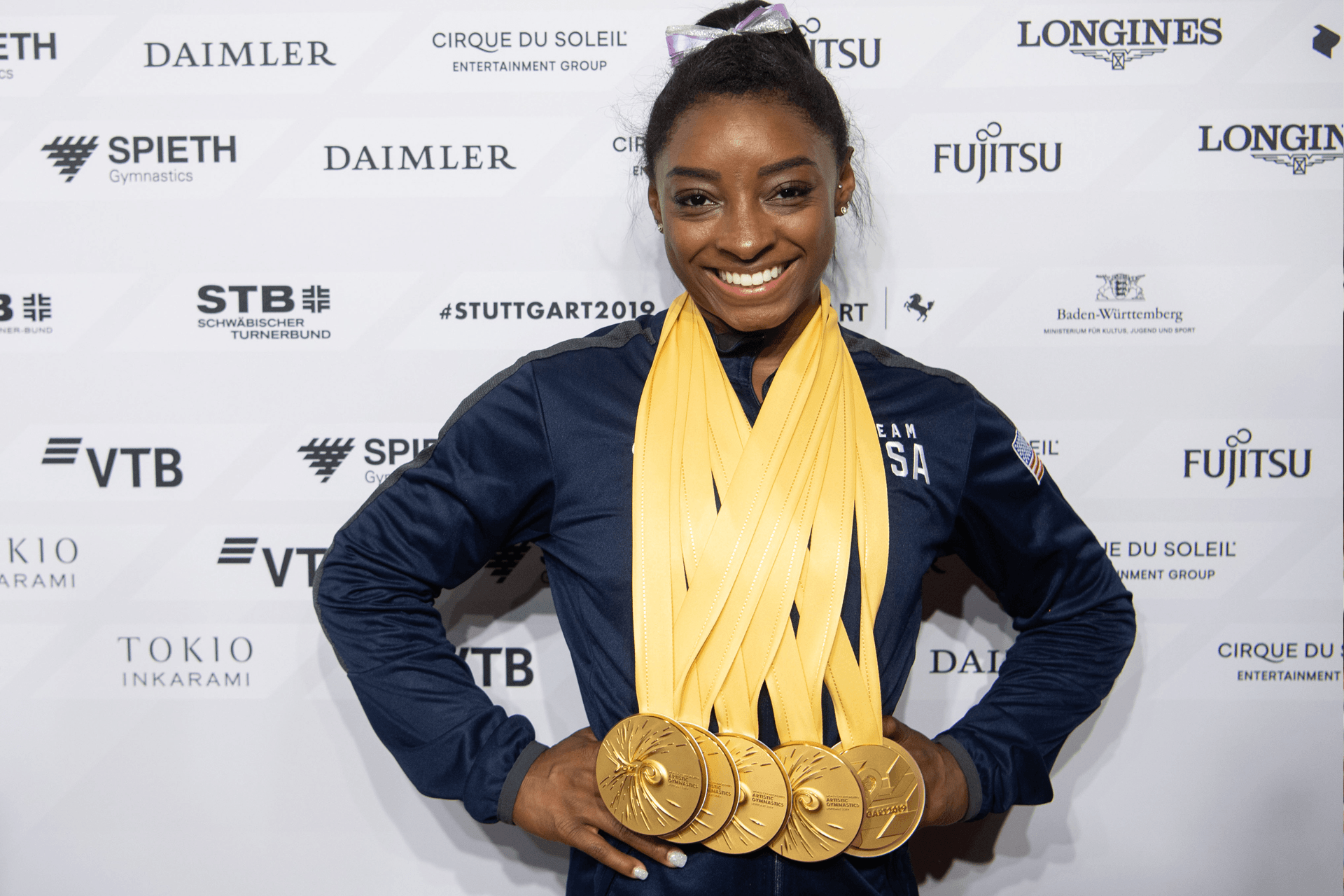 Simone Biles wearing 5 gold medals
