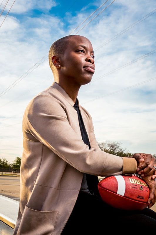 Odessa posing with a football for Plano Magazine