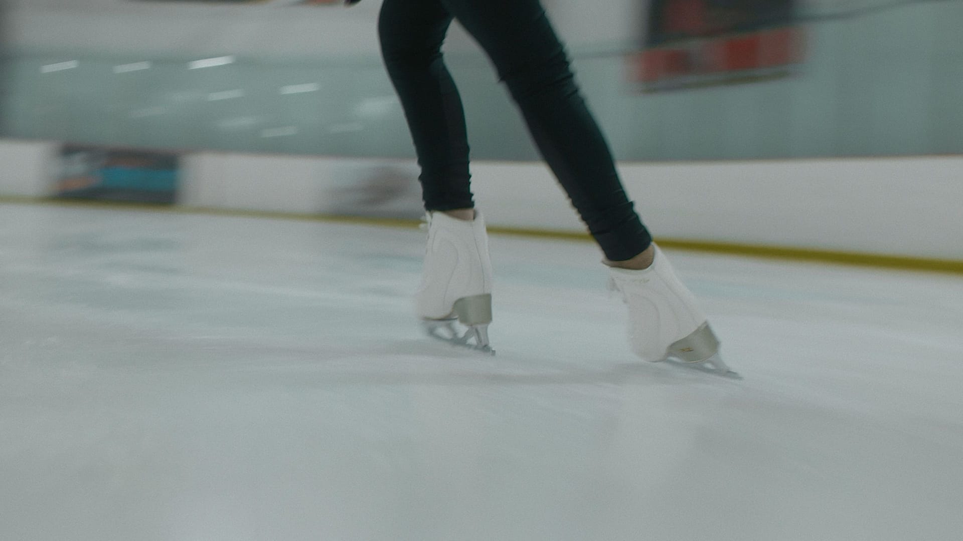 a figure skater's legs moving fast across the ice