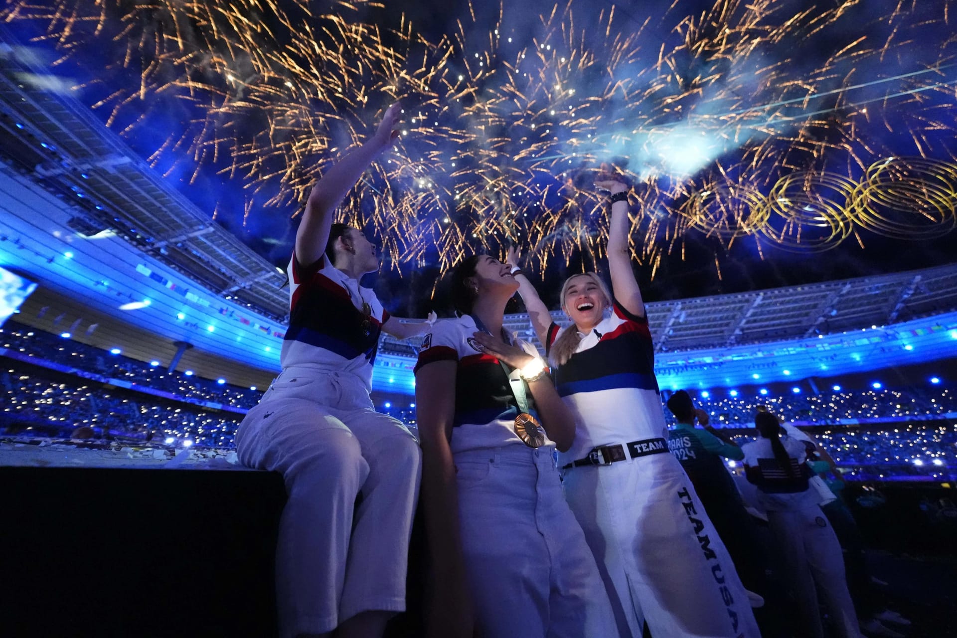 United States fencers Maia Weintraub, Jacqueline Dubrovich and Maia Chamberlain celebrate during the closing ceremony for the Paris 2024 Olympic Summer Games at Stade de France.