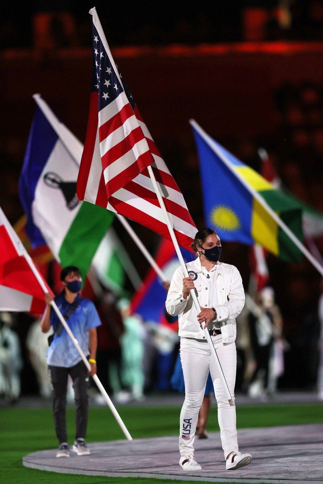 Kara carrying US flag at Olympic ceremony