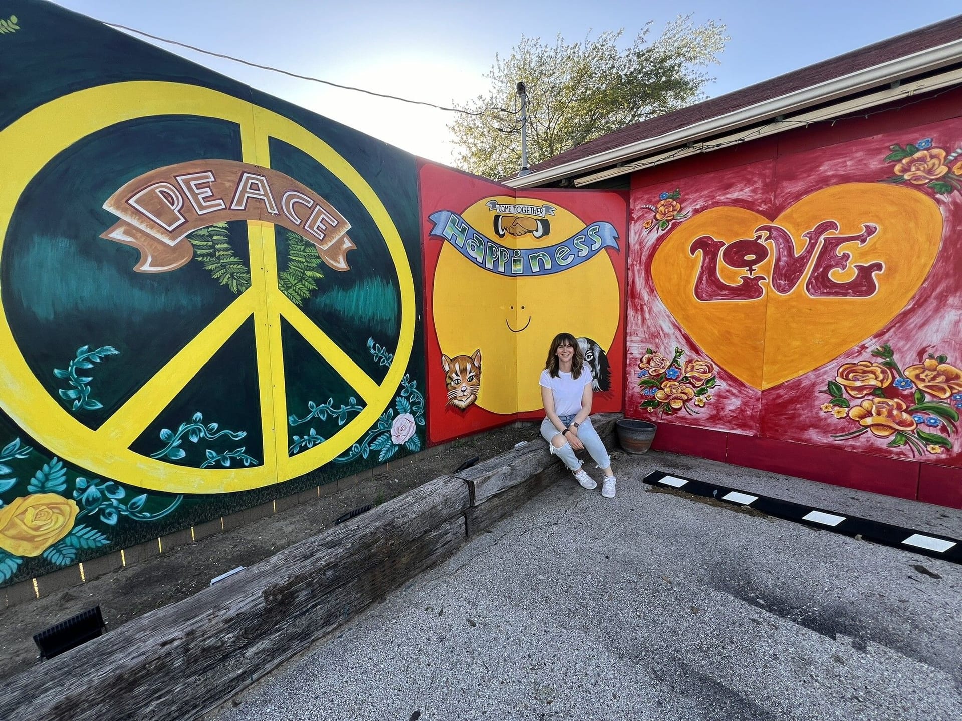 Samantha poses in front of painted street art