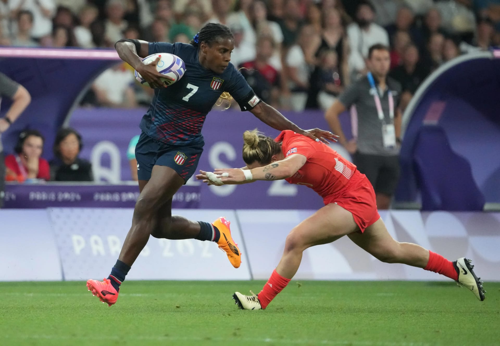 United States forward Naya Tapper runs the ball in a women's quarterfinal rugby match during the Paris 2024 Olympic Summer Games at Stade de France.