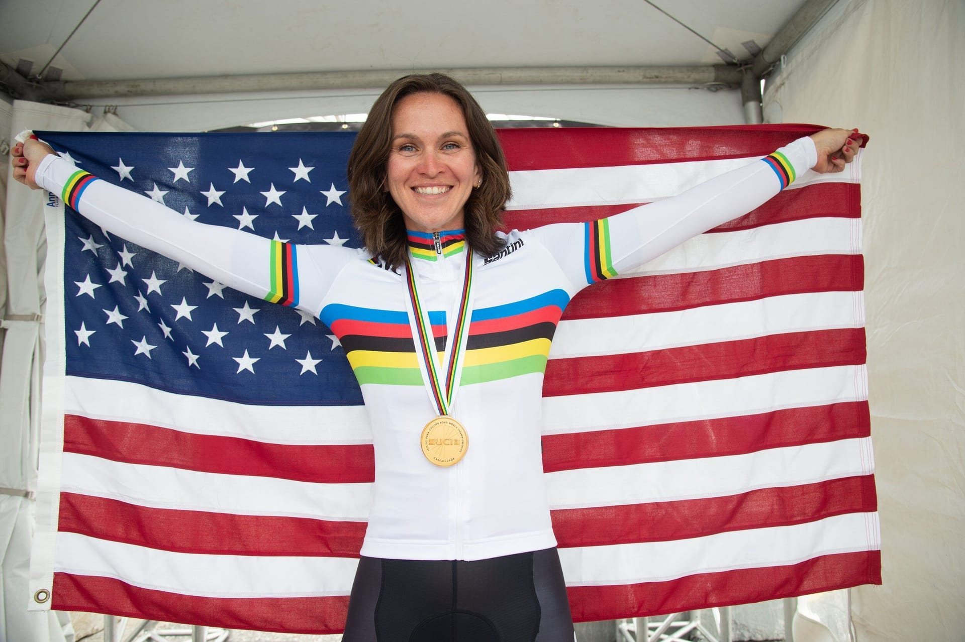 Samantha Bosco wearing gold medal and holding US flag