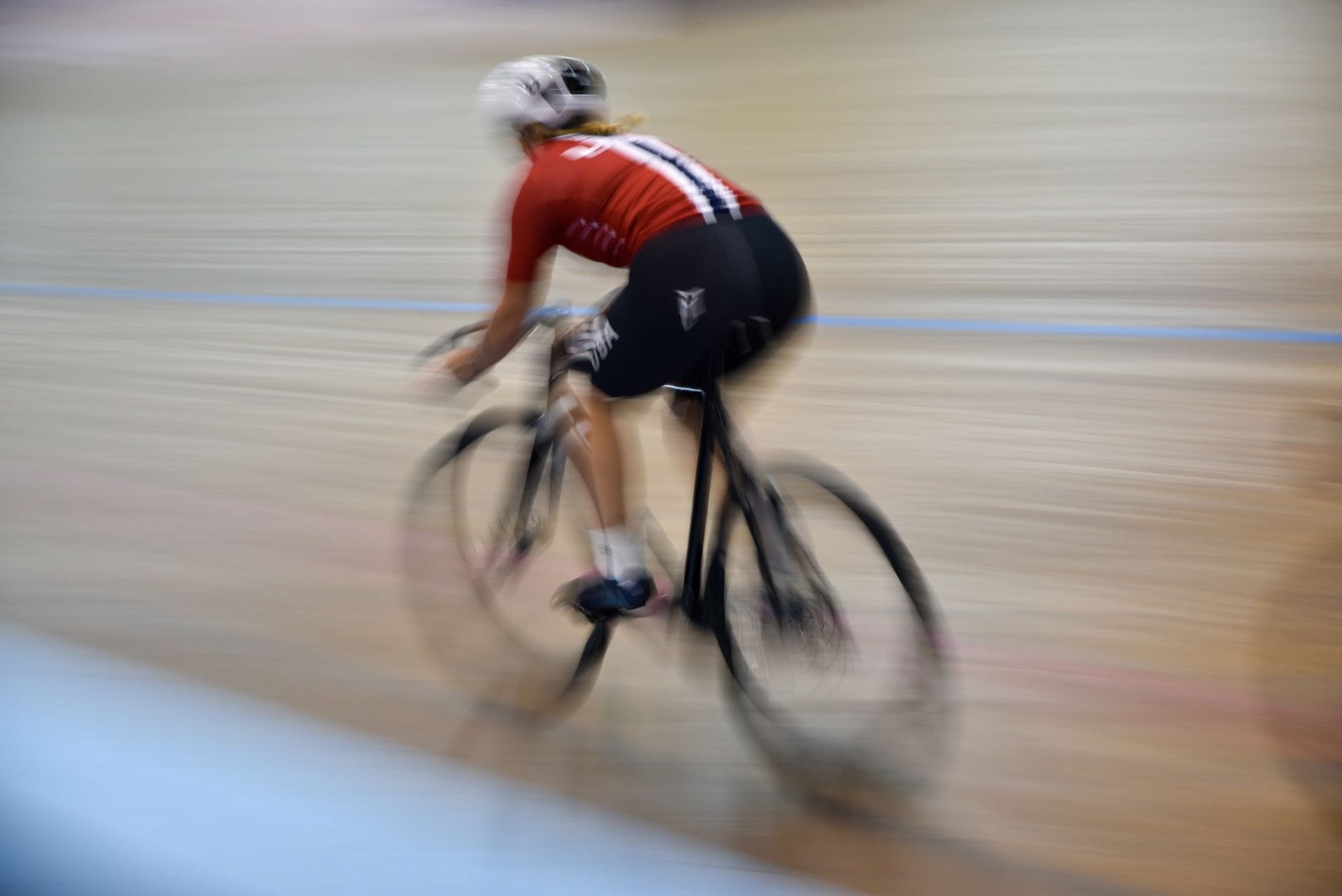 high speed blurred image of Mallory racing on her bike